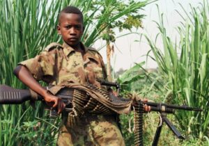 TO GO WITH AFP STORY ON UN HUMAN RIGHTS REPORT - (FILES) A young rebel soldier poses with his machine-gun on September 2, 1998 in Kalemie, southeast of DRC. The Office of the High Commissioner for Human Rights (OHCHR) release a final report on October 1, 2010 of the Mapping Exercise documenting the most serious human rights violations in the Democratic Republic of the Congo (DRC) between 1993 and 2003. Over 1,280 witnesses were interviewed, more than 1,500 documents were collected and analysed covering more than 600 incidents in the DRC in which hundreds of thousands of people were killed, injured and victimzed in other ways, including large numbers of women and children. AFP PHOTO / (Photo credit should read ABDELHAK SENNA/AFP/Getty Images)